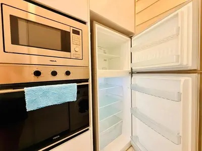 a kitchen with an open refrigerator and a microwave at 2BR Luxury Rooftop Swimming Pool Beacon Georgetown10pax \u65e0\u654c\u7f8e\u666f\u4e24\u623f\u6c11\u5bbf in George Town