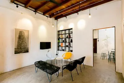 a room with a table and chairs and a tv at Central Georgetown - Loft House in George Town