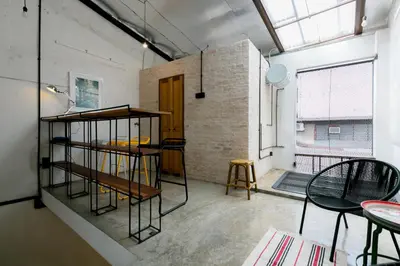 a room with a book shelf and a table at Central Georgetown - Loft House in George Town