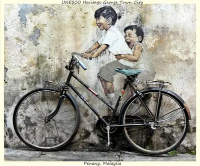 a bike parked in front of a wall with a painting at Central Georgetown - Loft House in George Town