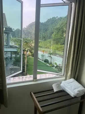 a window with a bench and a view of a mountain at LOW SEASON PROMOTION! Mountainview Corner Lot 10 pax in Ipoh