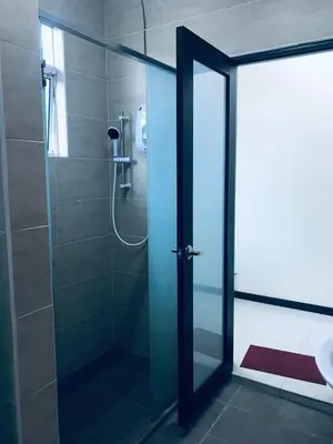 a shower with a glass door in a bathroom at LOW SEASON PROMOTION! Mountainview Corner Lot 10 pax in Ipoh