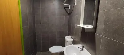 a bathroom with a white toilet and a sink at Olive Bedz Hotel in Tambun