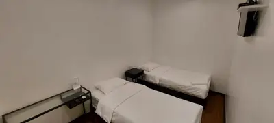 two beds in a small room with white walls at Olive Bedz Hotel in Tambun