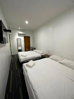 a hotel room with two beds and a tv at Olive Bedz Hotel in Tambun