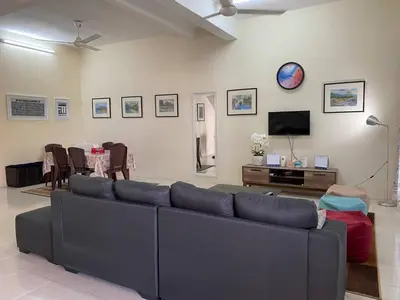 a living room with a couch and a tv at Spacious cozy Lakeville homestay 4 bedrooms all with AirCond in Seri Iskandar