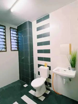 a bathroom with a toilet and a sink at Spacious cozy Lakeville homestay 4 bedrooms all with AirCond in Seri Iskandar