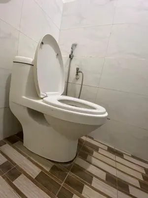 a toilet with the lid up in a bathroom at Hotel station 24 in Sungai Besar