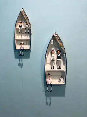 two toy dolls in a mirror on a wall at Hotel station 24 in Sungai Besar