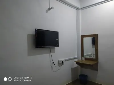 a flat screen tv hanging on a wall at Hotel station 24 in Sungai Besar