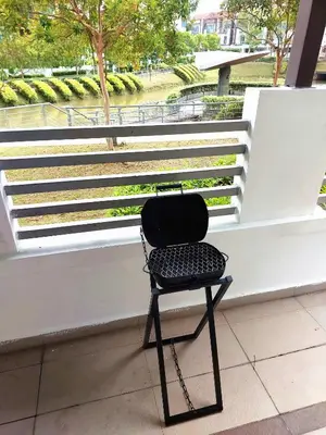 a black chair sitting in front of a white wall at ●STG12●3-Storey●Private House●2step Access Garden● in Bayan Lepas