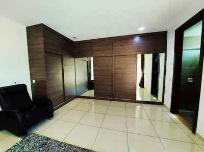 a living room with a black chair and wooden wall at ●STG12●3-Storey●Private House●2step Access Garden● in Bayan Lepas