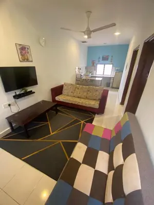 a living room with a couch and a tv at MAMA homestay in Bagan Serai