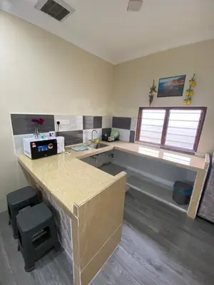an office with a counter and a desk and window at MAMA homestay in Bagan Serai