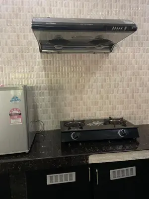 a stove top oven sitting on top of a counter at Homestay Seri Pangkor in Pangkor