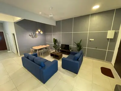 a living room with two blue couches and a table at Golden Hill Home by Dreamscape in Cameron Highlands
