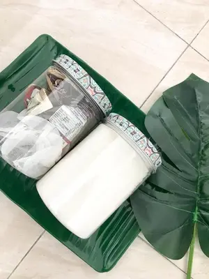 a green bag sitting on the floor with a magazine at Teratak Ar-Rayyan x Villa Abi in Batu Kurau