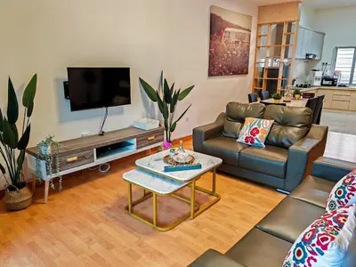 a living room with a couch and a flat screen tv at W25 atGoldenHills NightMarket WiFi 4R in Brinchang