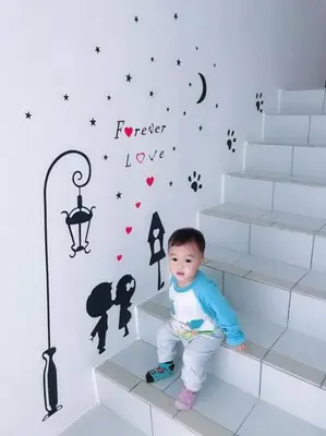 a young child sitting on some stairs in a room at W3WarmStay@GoldenHills/3RPenthouse/WiFi/PasarMalam/2carpark in Brinchang
