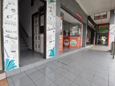 an empty hallway of a building with signs on the windows at Hotel Rasa Sayang 2 in Tanah Rata