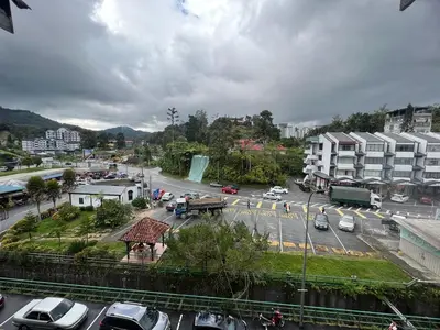a city street with cars parked in a parking lot at Hotel Rasa Sayang 2 in Tanah Rata