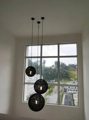 three lights hanging in front of a large window at W6WarmStay@GoldenHills/3RPenthouse/WiFi/PasarMalamView/2carpark in Brinchang