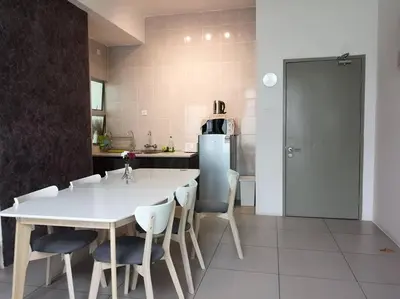 a kitchen with a white table and chairs and a refrigerator at W6WarmStay@GoldenHills/3RPenthouse/WiFi/PasarMalamView/2carpark in Brinchang