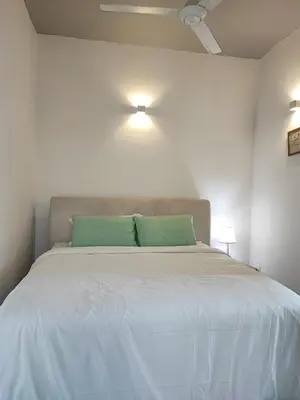 a bedroom with a large bed with a green pillow at W6WarmStay@GoldenHills/3RPenthouse/WiFi/PasarMalamView/2carpark in Brinchang