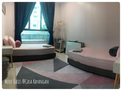 two beds in a room with a window at Meru Oasis at Casa Kayangan Ipoh in Ipoh