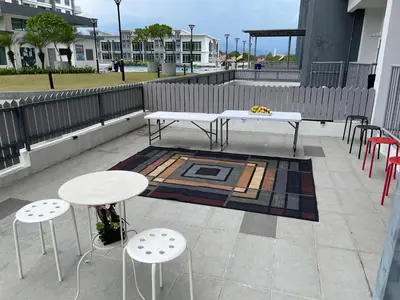 a patio with two tables and chairs and a rug at Meru Oasis at Casa Kayangan Ipoh in Ipoh