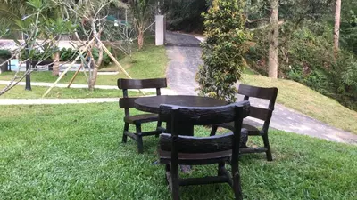 two chairs and a table in the grass at Kemuning Orchard Villaa in Kerling