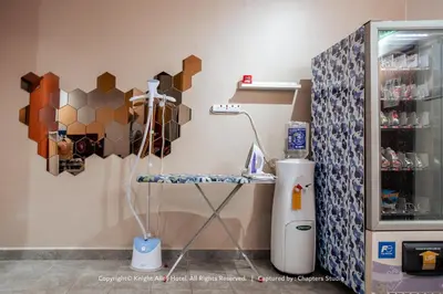 a room with a table and a refrigerator at Knight Alley Hotel in Taiping