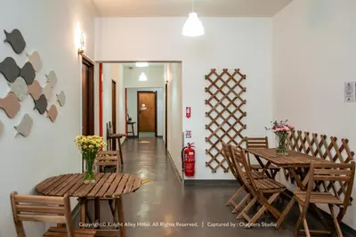 a dining room with wooden tables and chairs and a fire extinguisher at Knight Alley Hotel in Taiping