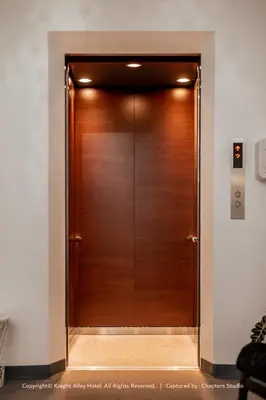 a large wooden door in a room with at Knight Alley Hotel in Taiping