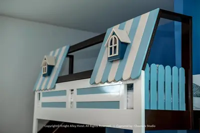 a toy house with two windows and a fence at Knight Alley Hotel in Taiping