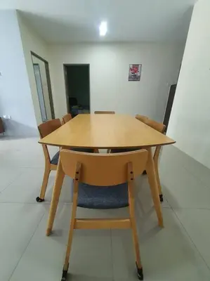 a wooden table and chairs in a room at Manhattan Condo Ipoh with Water Park and Pool View in Ipoh