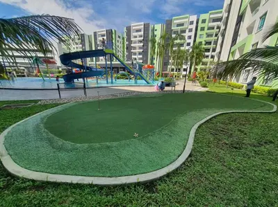 a playground with a slide in a park at Manhattan Condo Ipoh with Water Park and Pool View in Ipoh