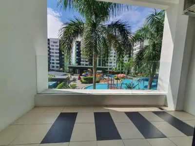 a room with a window with a view of a pool at Manhattan Condo Ipoh with Water Park and Pool View in Ipoh