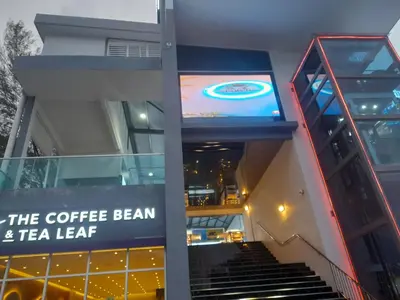 a building with a coffee bean and tea leaf sign at AGODA C VIEW @ Sri Sayang Beach Resort in Batu Ferringhi