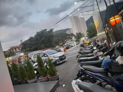 a row of motorcycles parked in a parking lot at AGODA C VIEW @ Sri Sayang Beach Resort in Batu Ferringhi