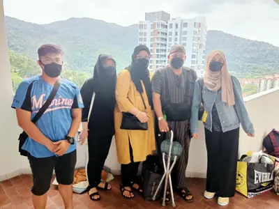 a group of people wearing masks posing for a picture at AGODA C VIEW @ Sri Sayang Beach Resort in Batu Ferringhi