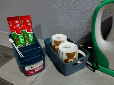 a blue lunch box with cups and a mug at Alish Homestay Gua Musang with Free WiFi, Netflix in Gua Musang