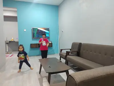 a woman and a little girl standing in a room at Alish Homestay Gua Musang with Free WiFi, Netflix in Gua Musang