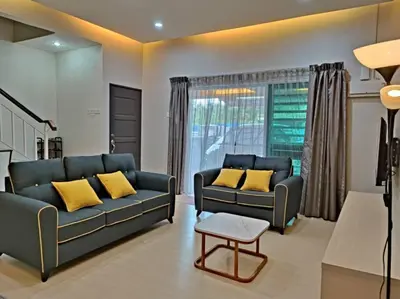 a living room with two blue couches and yellow pillows at W13 atGoldenHills NightMarket WiFi 4R in Brinchang