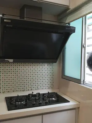 a kitchen with a stove top with a window at W13 atGoldenHills NightMarket WiFi 4R in Brinchang