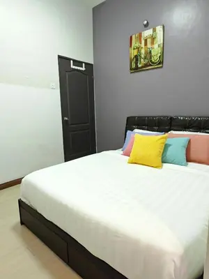 a bedroom with a large bed with colorful pillows at W13 atGoldenHills NightMarket WiFi 4R in Brinchang