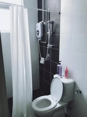 a bathroom with a toilet with a shower curtain at W5WarmStay@Golden Hill/Penthouse/WiFi/3R/NightMarket/2CarPark in Brinchang