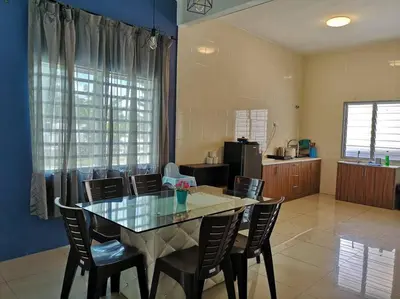 a dining room with a glass table and chairs at W36 WarmStay atGoldenHills NightMarket 4R Wifi BBQ in Brinchang