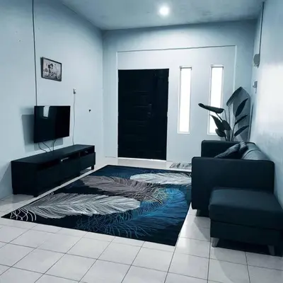 a living room with a black door and a rug at Homestay De' Humaira - USM Nibong Tebal in Nibung Tebal