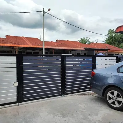 a blue car parked in front of a garage at Homestay De' Humaira - USM Nibong Tebal in Nibung Tebal
